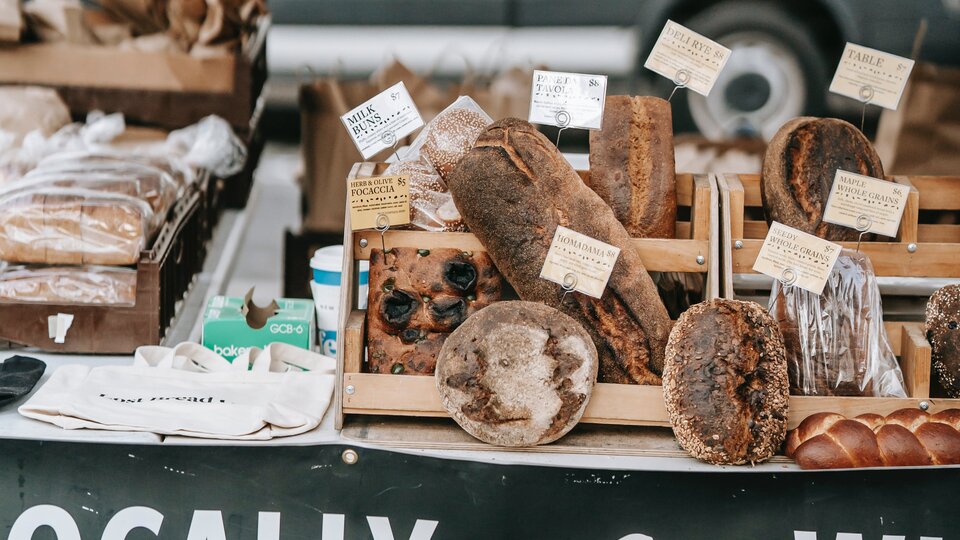 farmers market booth selling breads